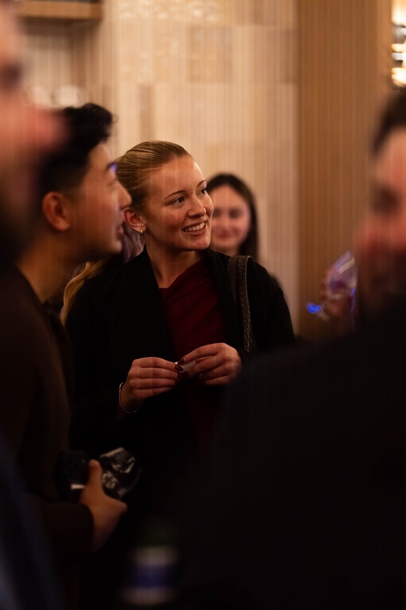 A member laughing in conversation at the mixer